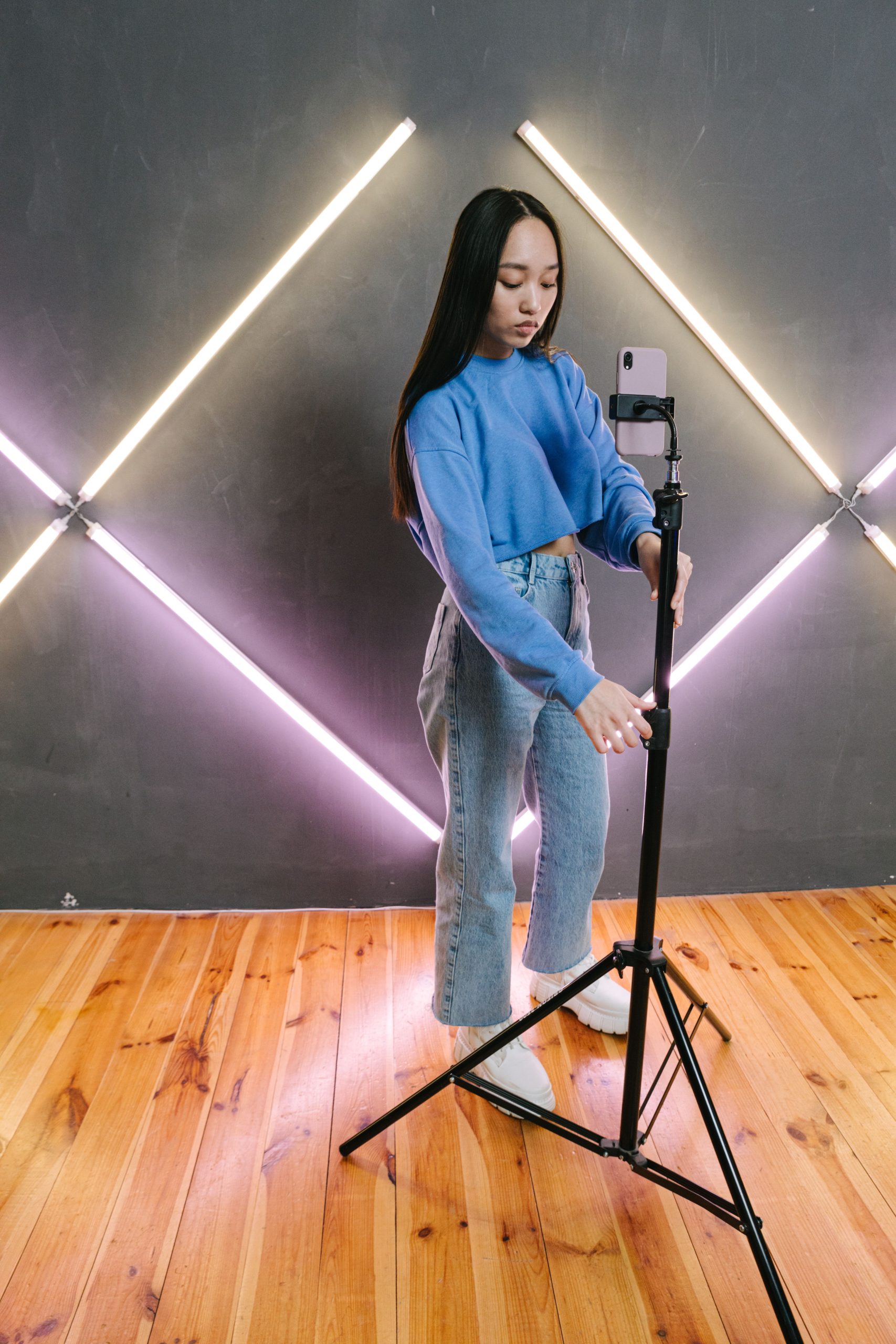 Content creator preparing a smartphone studio, representing creator digital twins and fan engagement