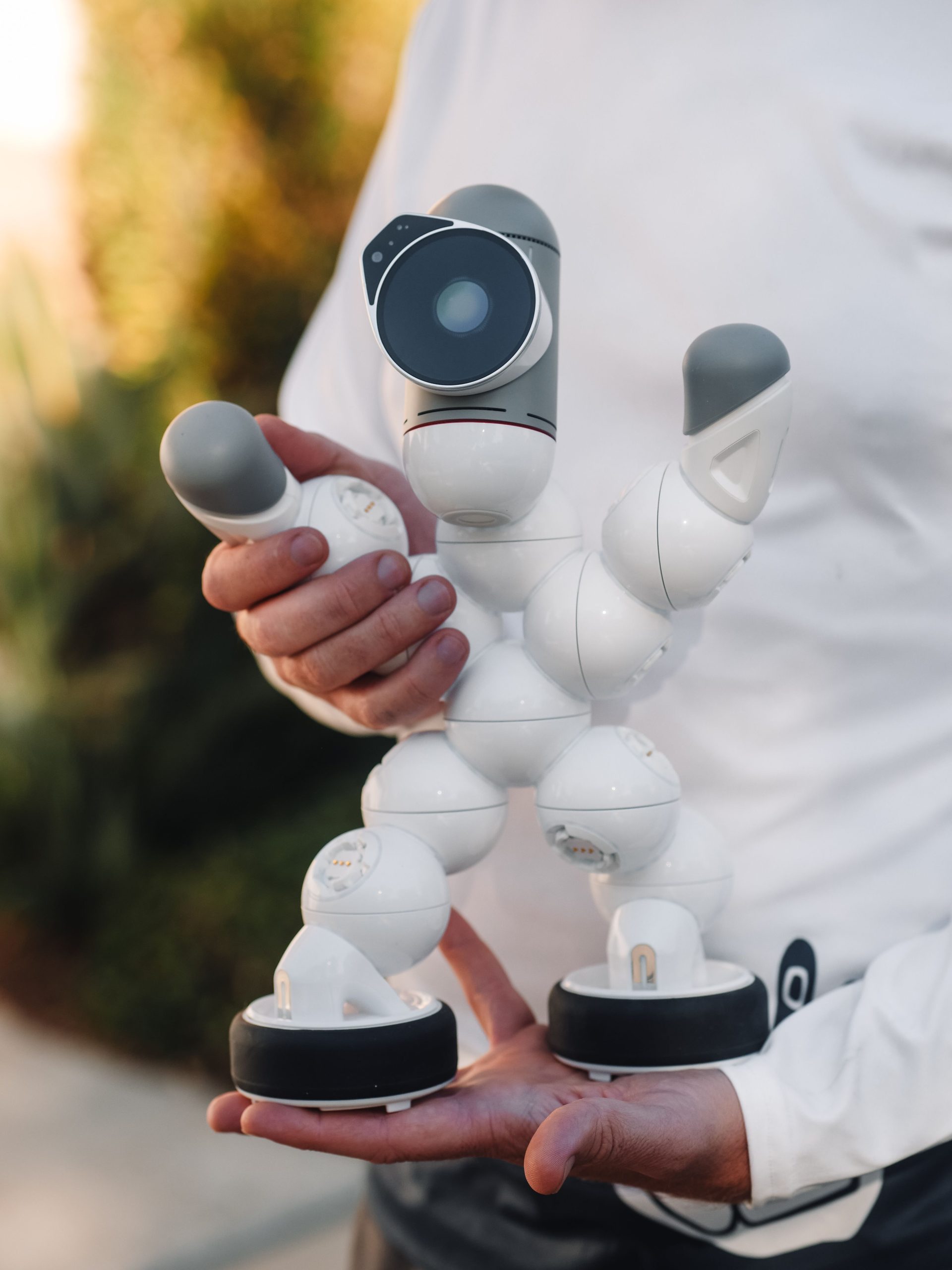 Human holding a modern humanoid robot representing AI video companions and real-time interaction