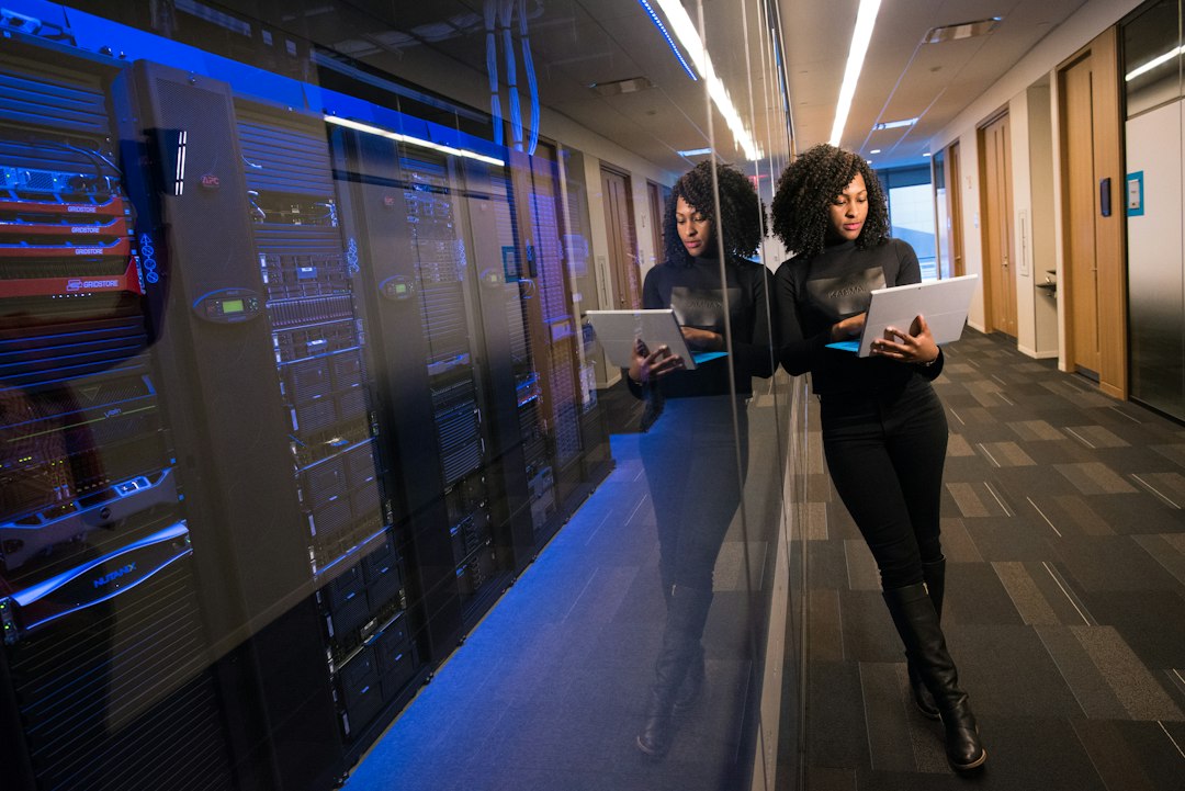 Woman using a laptop to illustrate creator digital twin commerce handoff